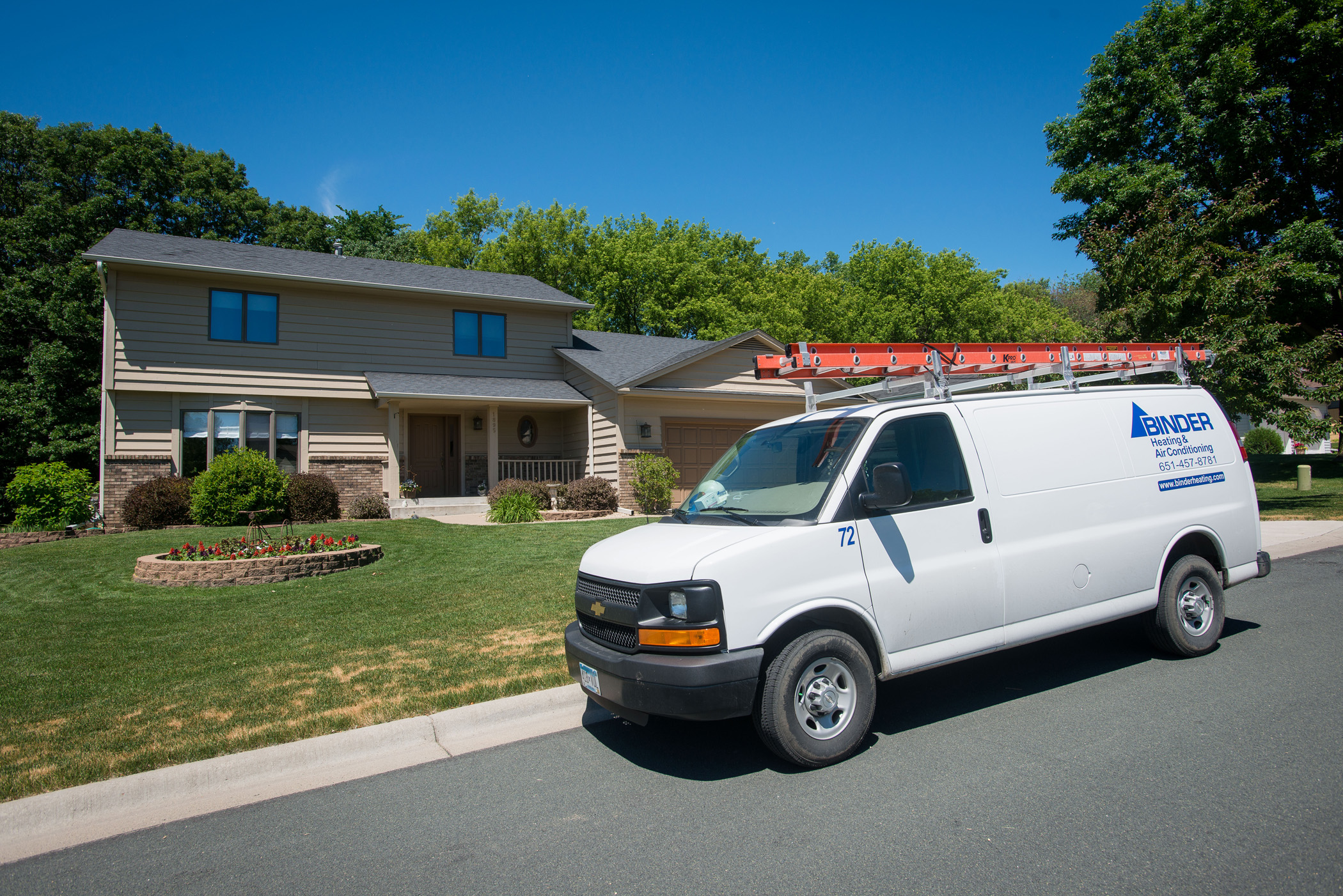 Binder HVAC service van parked in front of a suburban Minnesota home