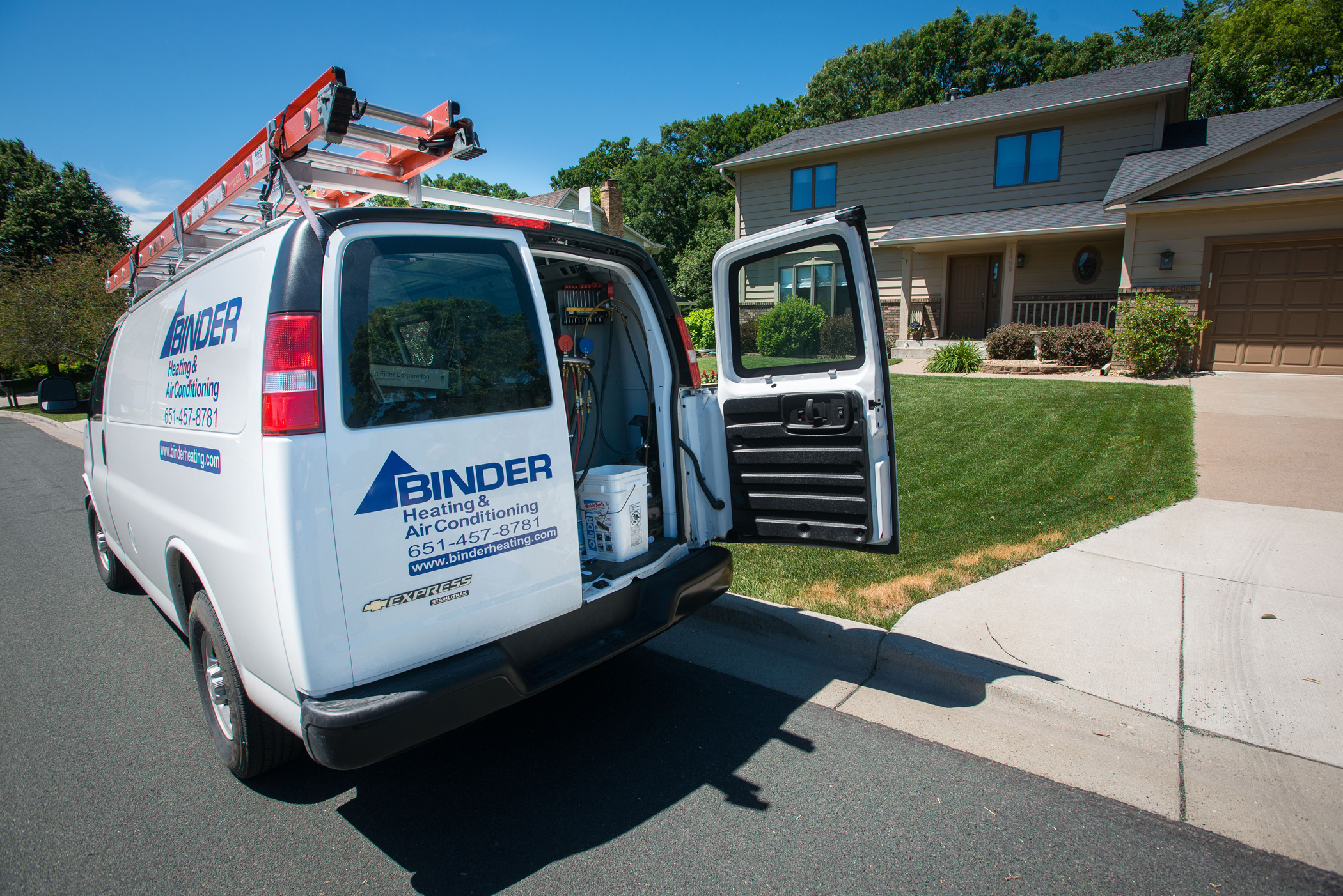 Binder HVAC service van parked outside a suburban Minnesota home