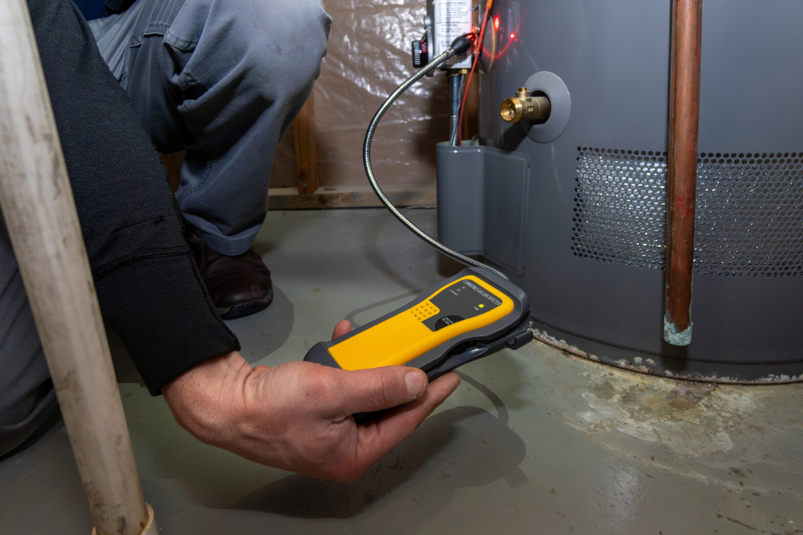 Home Inspector searching and using UEFI carbon monoxide detector to test gas furnace