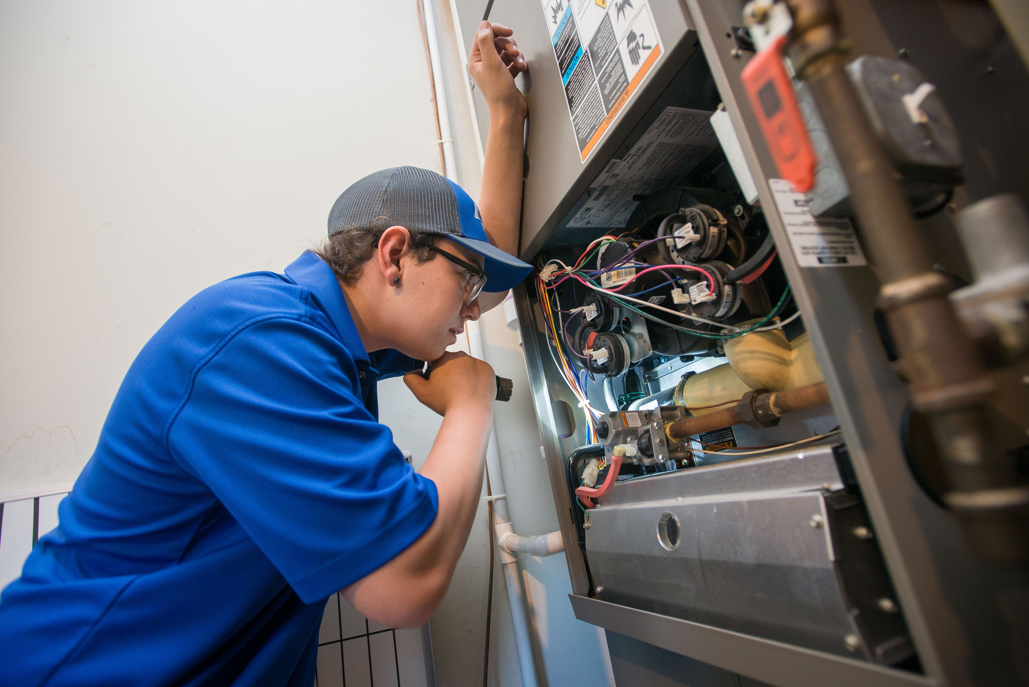 Binder service technician performing a furnace inspection