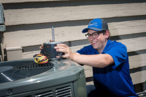Binder HVAC technician providing a residential A/C tune-up in St. Paul, Minnesota